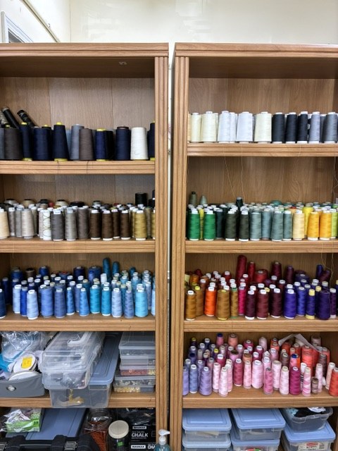 Thread organized by color — hundreds of spools in stock